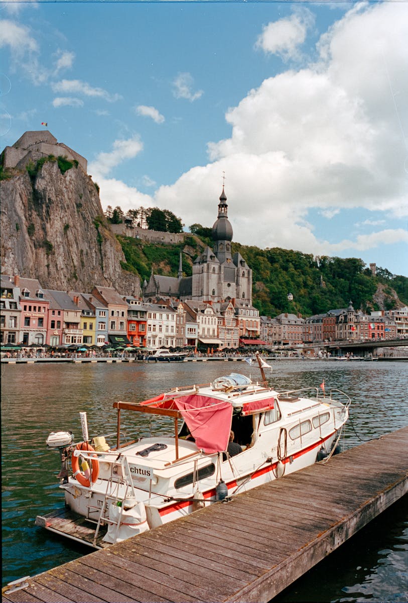 A boat is docked at a pier near a castle