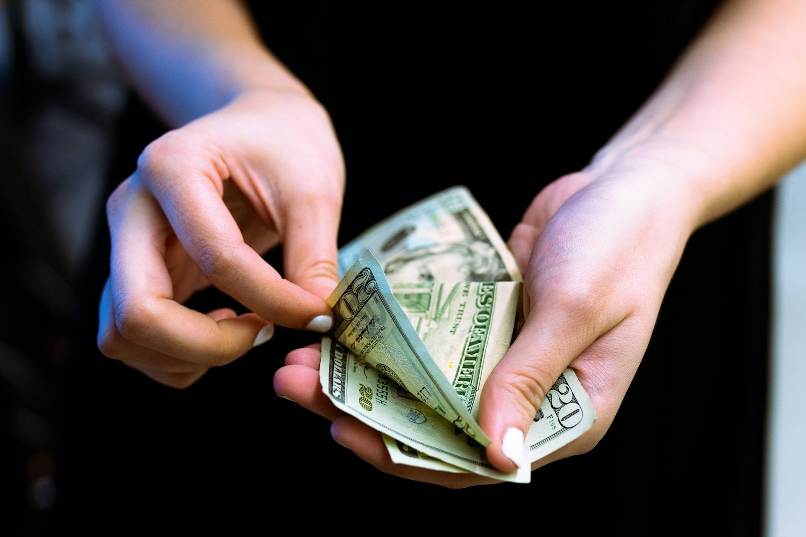 person holding fan of 100 us dollar bill, annuities