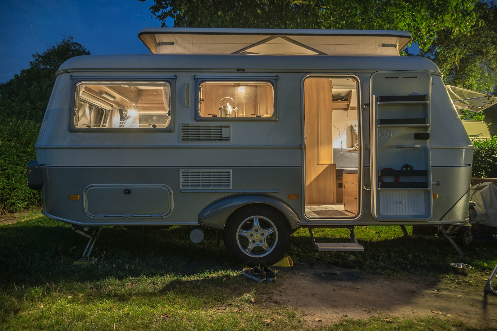 white and brown camper trailer beside tree, rv