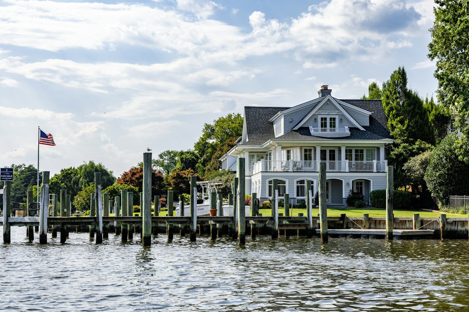 A large house with a dock on the water.